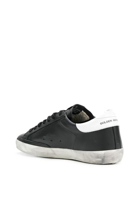 Sneakers Super-Star con effetto vissuto in bianco e nero Golden Goose - uomo GOLDEN GOOSE | GMF00101F00032180203