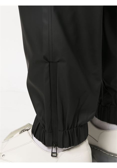 Pantaloni con coulisse di Rains in nero - unisex RAINS | RA18560BLA