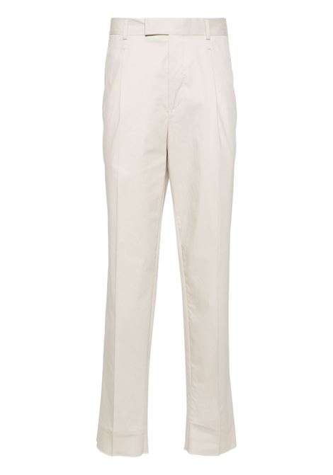 Beige mid-rise pleated chino trousers - men