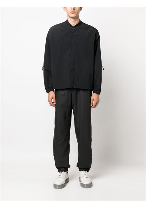 Pantaloni con coulisse di Rains in nero - unisex RAINS | RA18560BLA